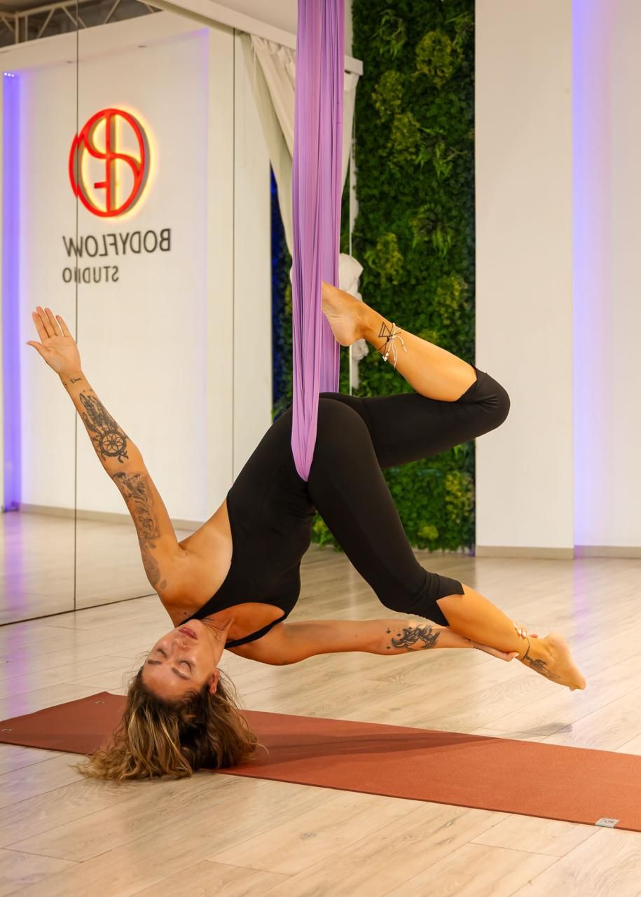 Aerial class pose in a lilac hammock